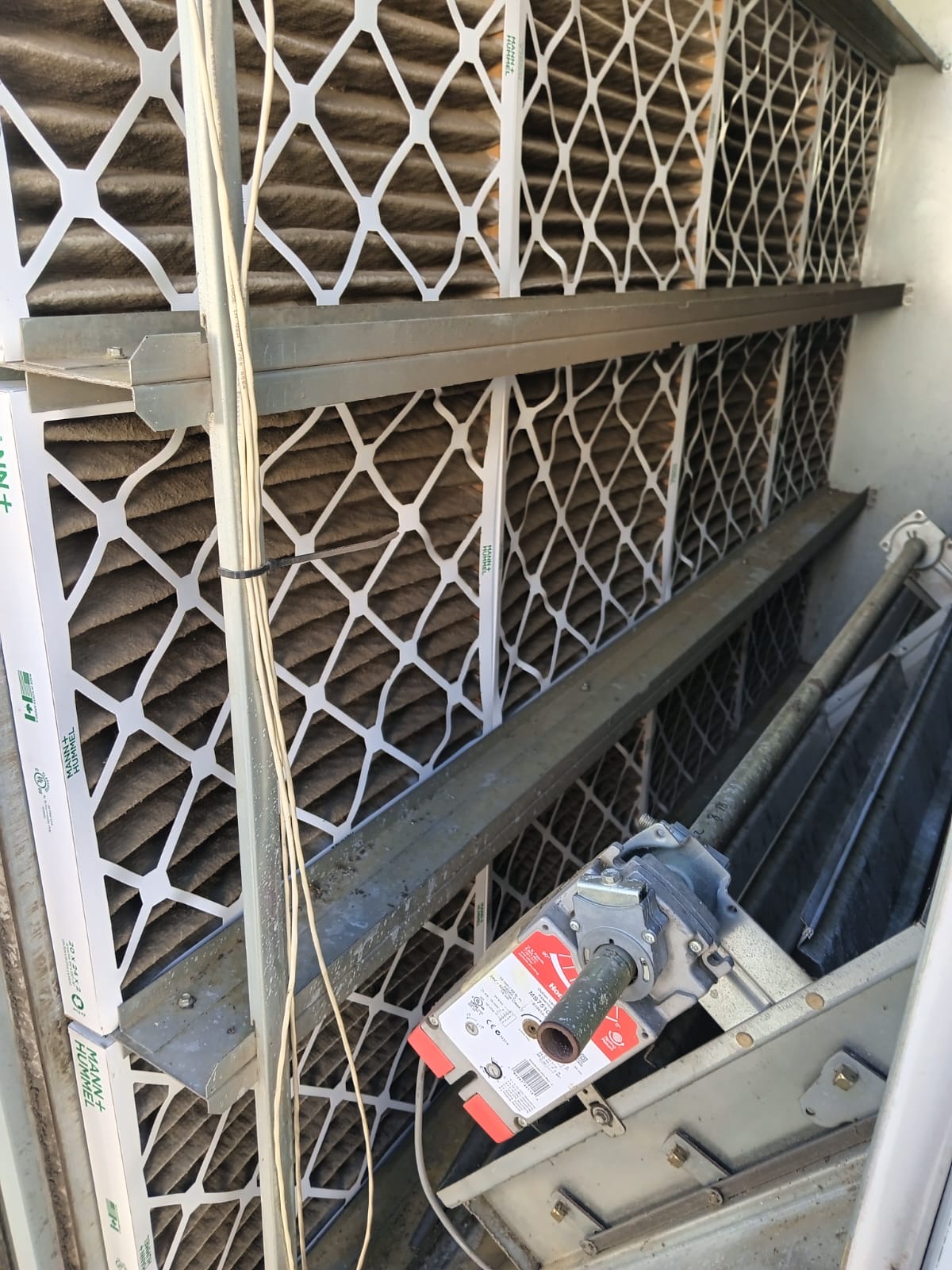 Clogged commercial HVAC filters being replaced