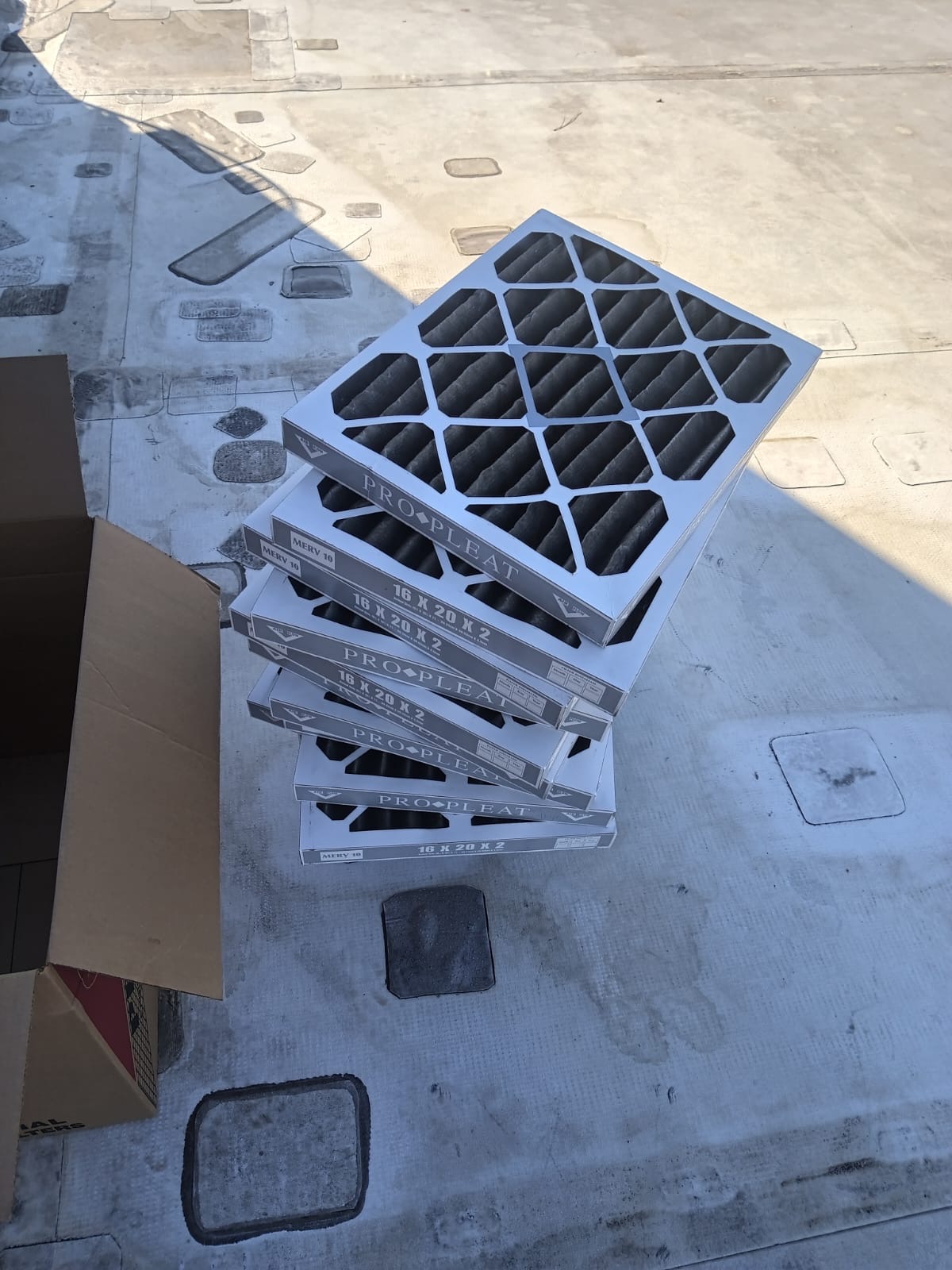 Stack of commercial Pro-Pleat air filters on a rooftop